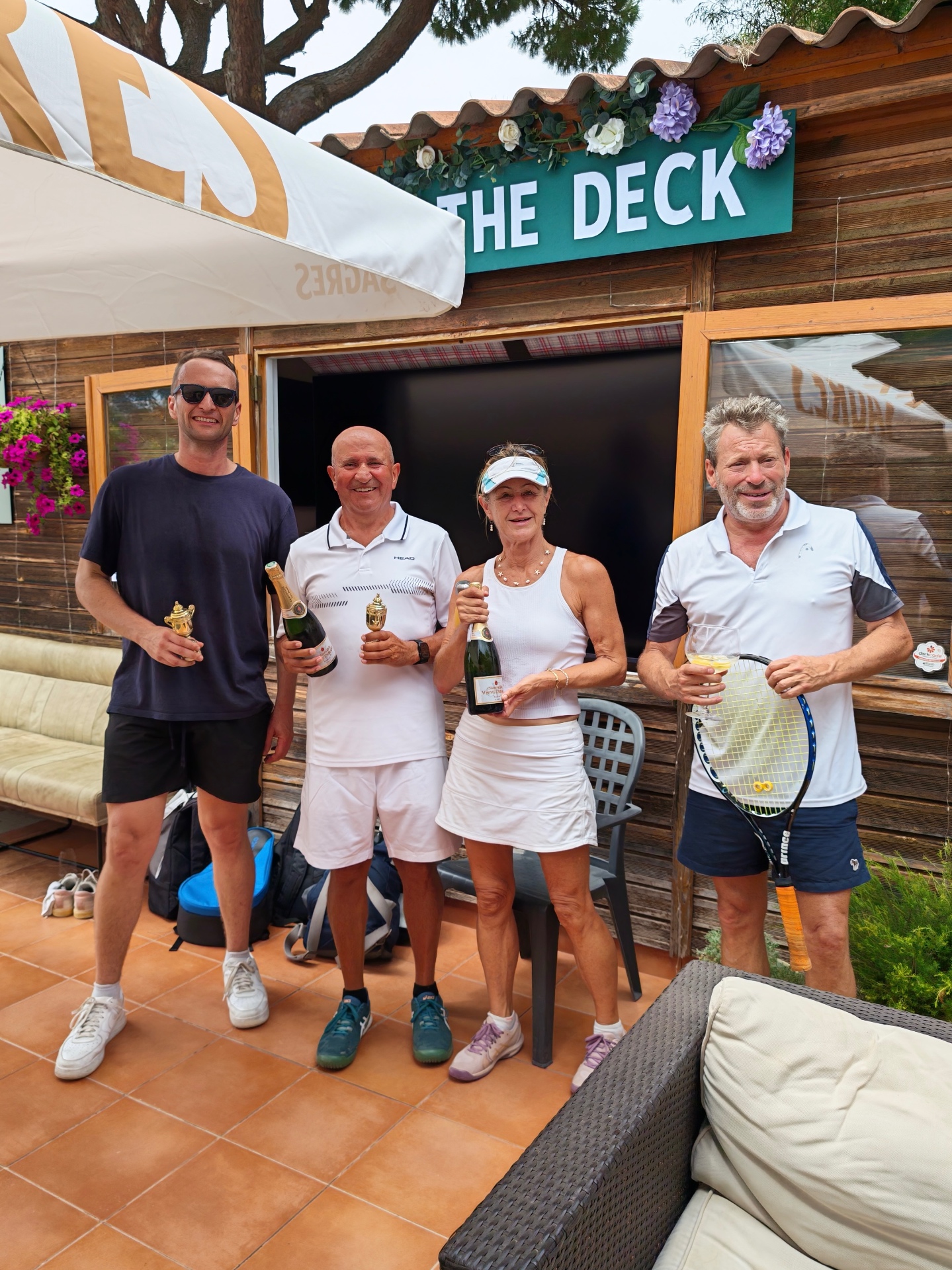 Tournament winners celebrating with champagne at The Deck