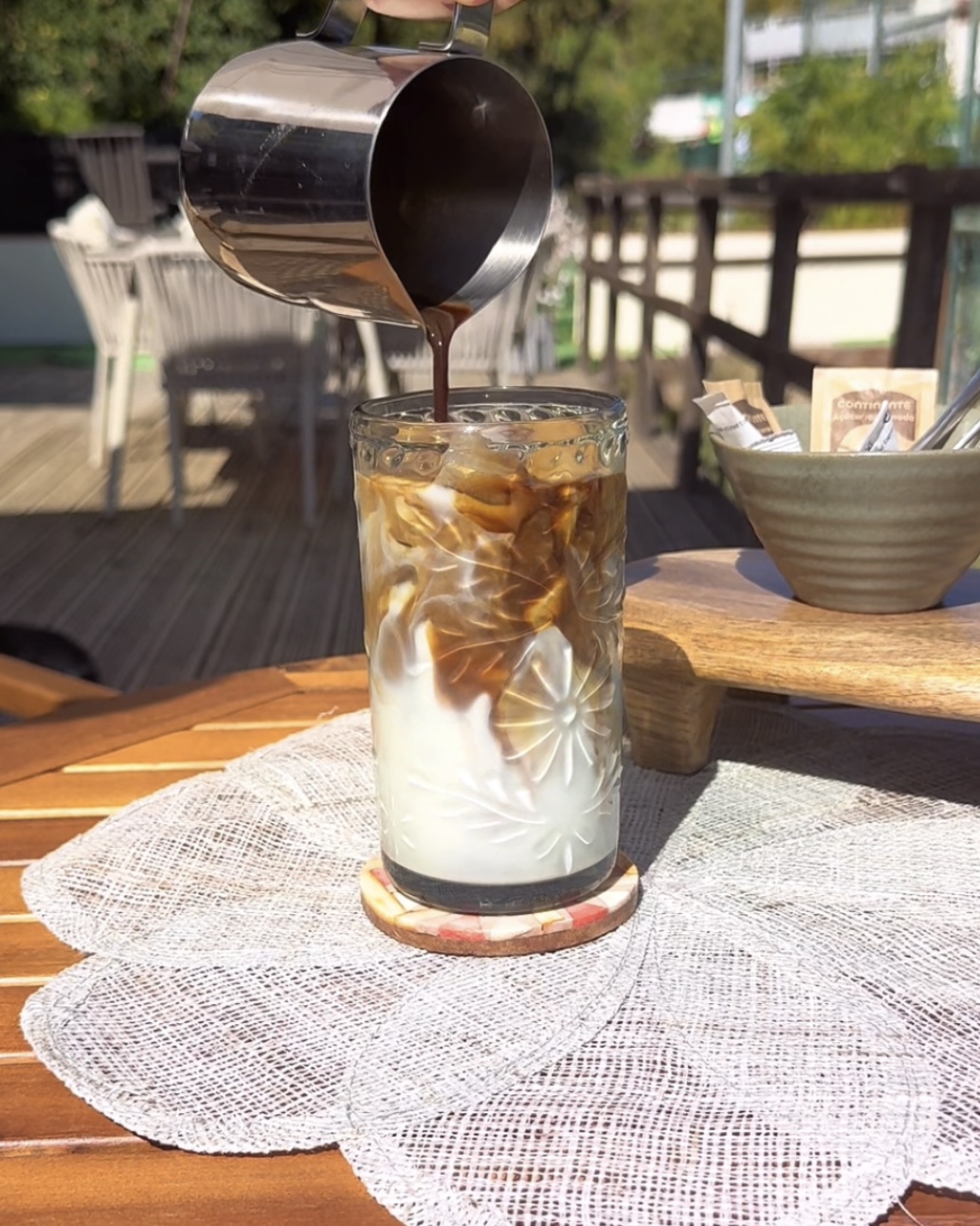 Iced coffee being poured at Jardins café