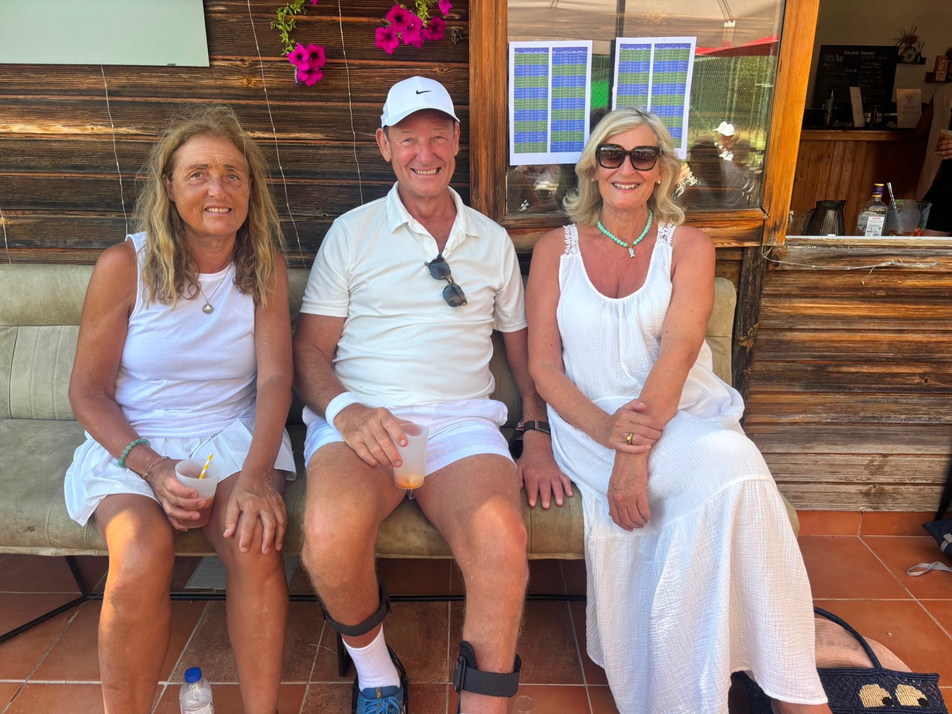 Friends enjoying drinks at the Jardins clubhouse after tennis